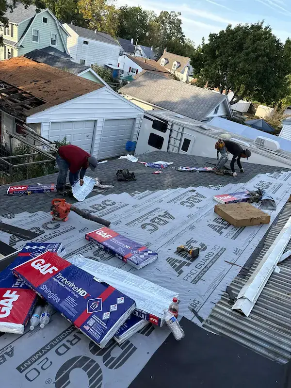 Right Deal Roofing & Chimney crew installing GAF shingles