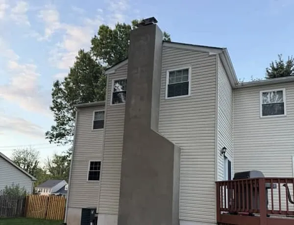 Completed chimney rebuild with new stainless liner, concrete crown, and matching brick on a Doylestown PA colonial