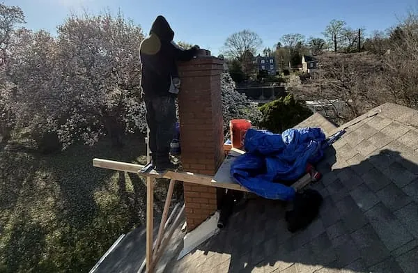 Completed chimney tuckpointing and new cap on a Chalfont PA split-level home, January 2025