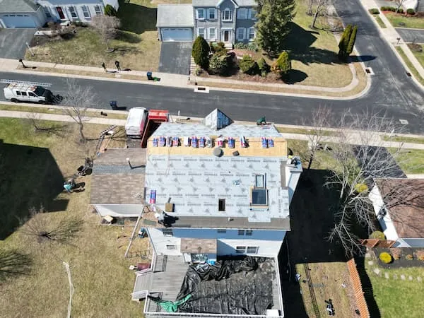 Deteriorated 3-tab shingle roof on a Doylestown PA colonial showing granule loss and lifted tabs before replacement
